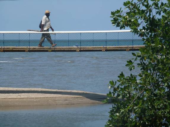 Ponte sobre foz de rio em praia de Livingston, no litoral da Guatemala